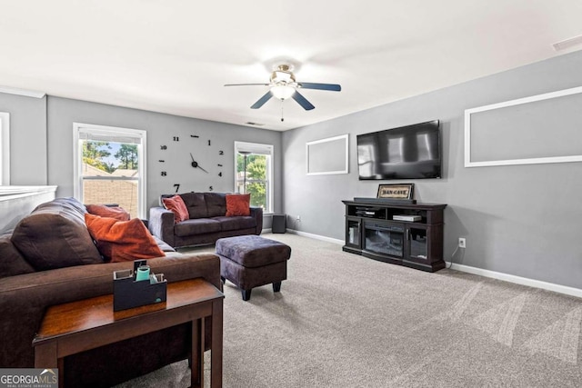 carpeted living room featuring ceiling fan and a healthy amount of sunlight