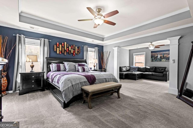 bedroom featuring a raised ceiling, carpet flooring, and ceiling fan