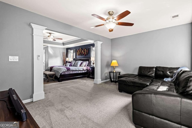 carpeted living room featuring decorative columns and ceiling fan