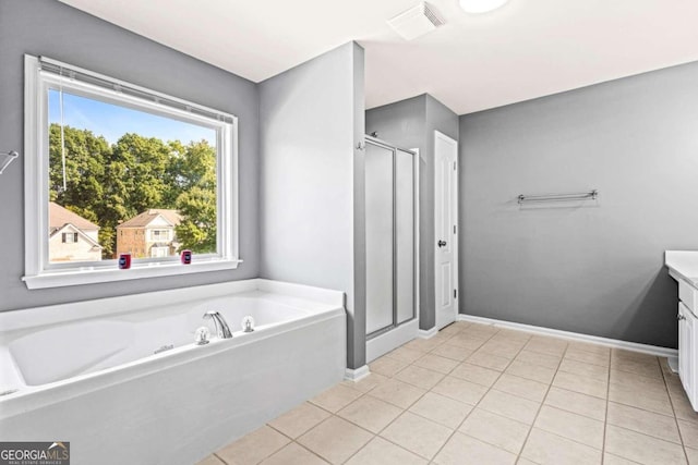 bathroom featuring vanity, shower with separate bathtub, and tile patterned floors