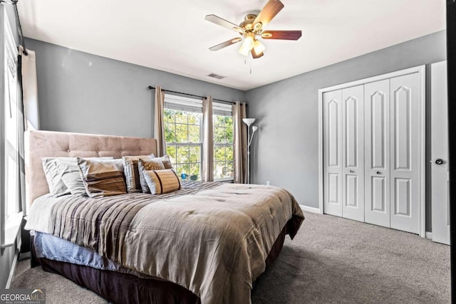 carpeted bedroom featuring a closet and ceiling fan