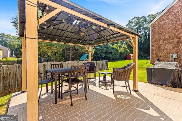 rear view of property with a gazebo, a yard, and a patio area