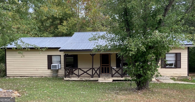 view of front of house featuring a front yard and cooling unit