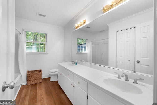 full bathroom featuring hardwood / wood-style flooring, toilet, a textured ceiling, crown molding, and vanity