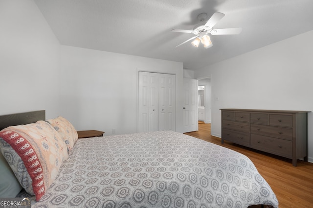 bedroom with a closet, ceiling fan, and light hardwood / wood-style flooring