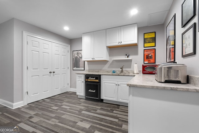 kitchen with sink, white cabinets, and dark hardwood / wood-style floors