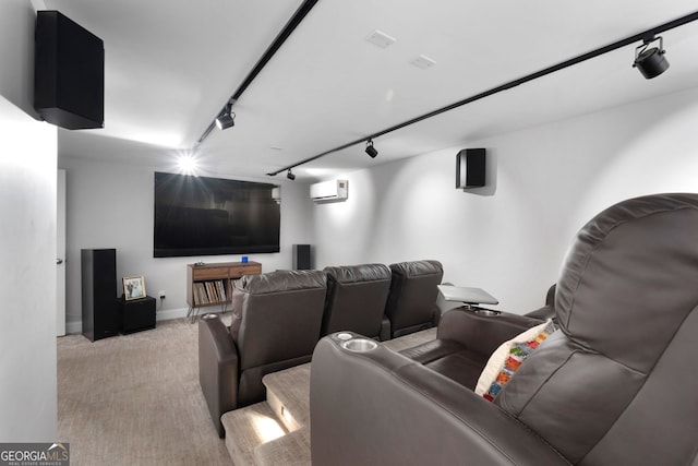 cinema room with an AC wall unit, light colored carpet, and track lighting