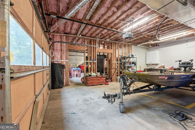 garage with a garage door opener and a workshop area