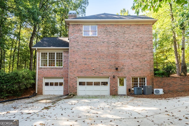 exterior space featuring central AC and a garage