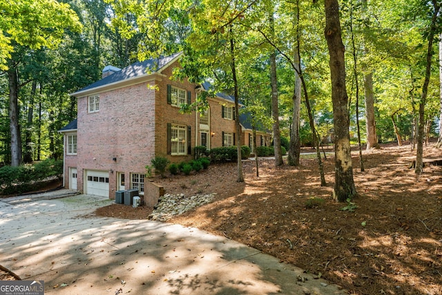 view of home's exterior featuring a garage and central air condition unit