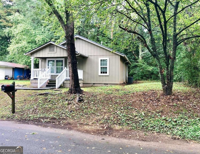 view of front of property featuring central AC and a porch