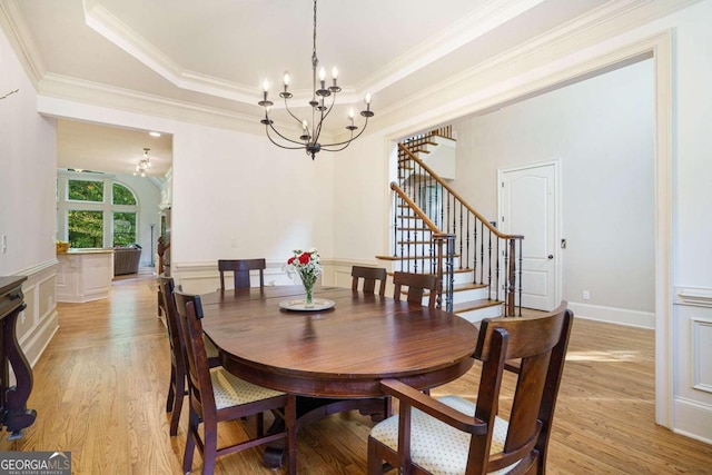 living room featuring hardwood / wood-style flooring, a towering ceiling, and plenty of natural light