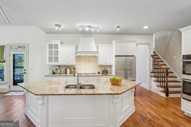 dining area with crown molding, a chandelier, light wood-type flooring, and a raised ceiling