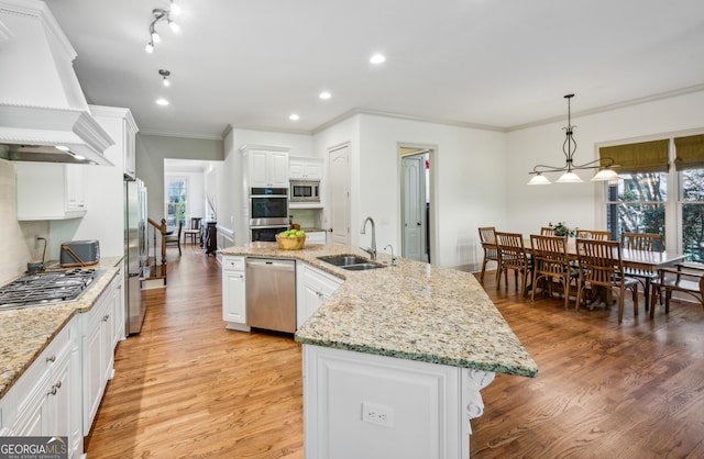 dining space with crown molding, a stone fireplace, and light wood-type flooring