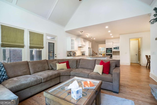 sitting room featuring ornamental molding and light hardwood / wood-style flooring