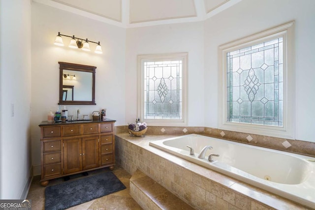 carpeted bedroom featuring crown molding, ensuite bath, a tray ceiling, and ceiling fan