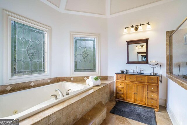 bathroom with vanity, beam ceiling, a wealth of natural light, and tiled tub