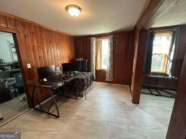 home office with wood walls and ornamental molding