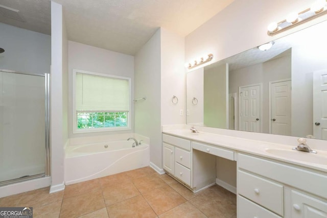 bathroom featuring vanity, separate shower and tub, a textured ceiling, and tile patterned floors