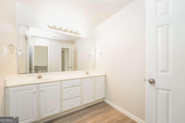 bathroom with wood-type flooring and vanity