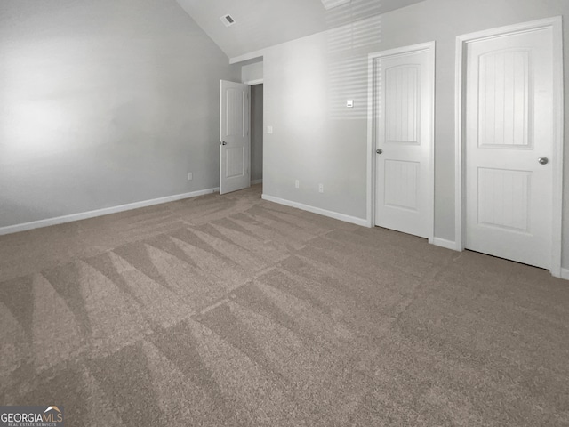 unfurnished bedroom featuring vaulted ceiling and carpet flooring