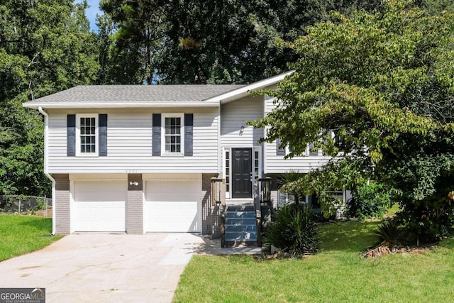 split foyer home with a garage and a front lawn