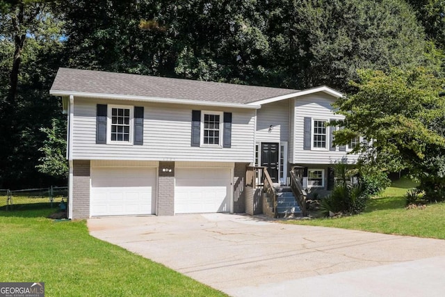 bi-level home with a garage and a front yard