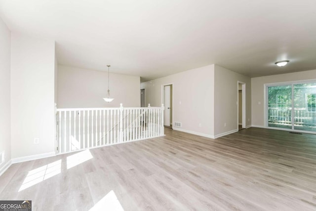 spare room featuring light hardwood / wood-style flooring