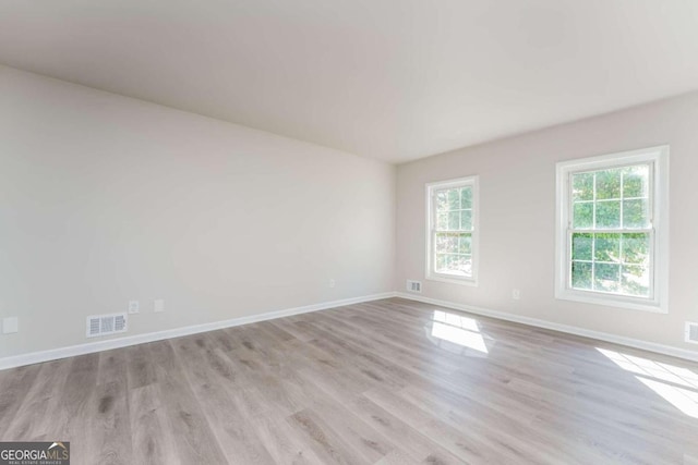 spare room featuring light wood-type flooring