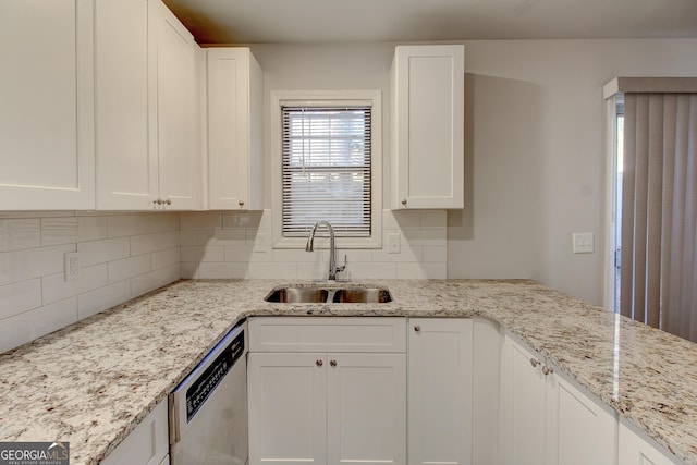 kitchen featuring sink, stainless steel dishwasher, white cabinets, and light stone counters