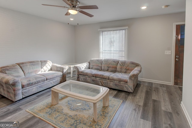 living room with hardwood / wood-style flooring and ceiling fan