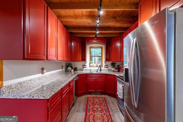 kitchen with wood ceiling, light wood-style flooring, light stone counters, appliances with stainless steel finishes, and beamed ceiling