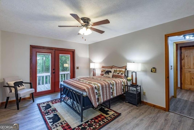 bedroom featuring access to outside, french doors, wood finished floors, and baseboards