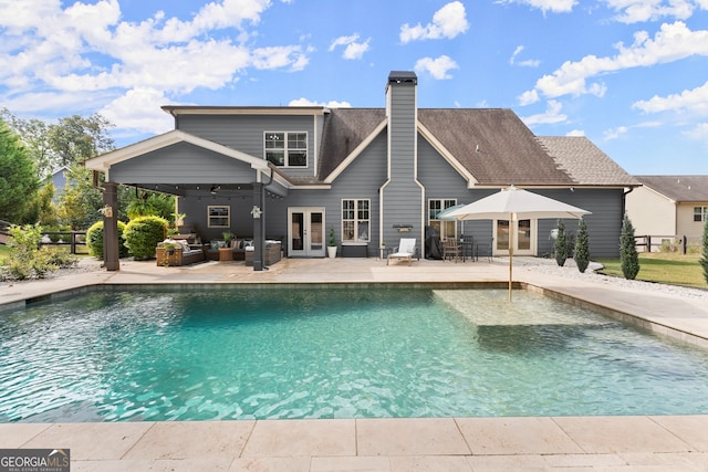 view of pool featuring outdoor lounge area, french doors, and a patio