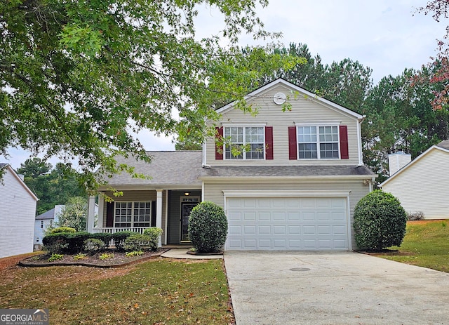 view of front of home with a front yard and a garage