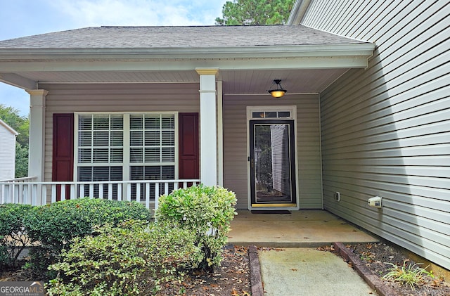 doorway to property featuring covered porch