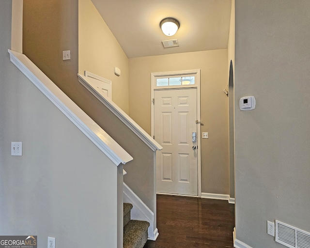 foyer with vaulted ceiling and dark hardwood / wood-style floors