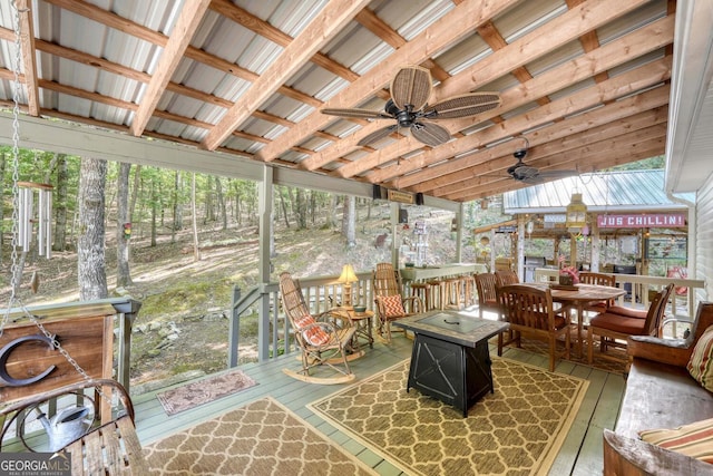 sunroom featuring ceiling fan and a wealth of natural light