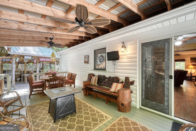 sunroom with wooden ceiling, beamed ceiling, and ceiling fan