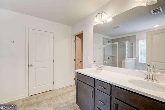 bathroom with a shower with door and vanity