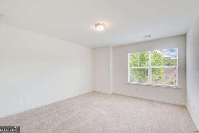 spare room with light colored carpet