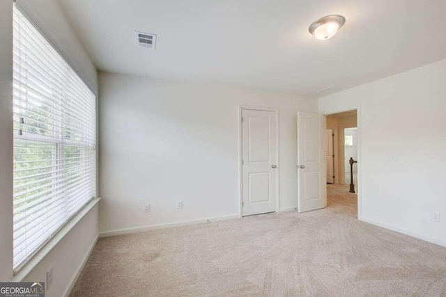 unfurnished bedroom with light carpet