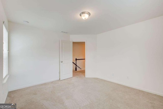 carpeted empty room with a wealth of natural light