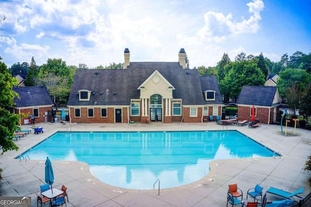 view of swimming pool with a patio