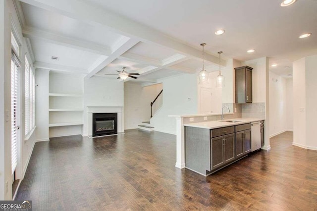 kitchen with dishwasher, dark hardwood / wood-style floors, sink, hanging light fixtures, and ceiling fan