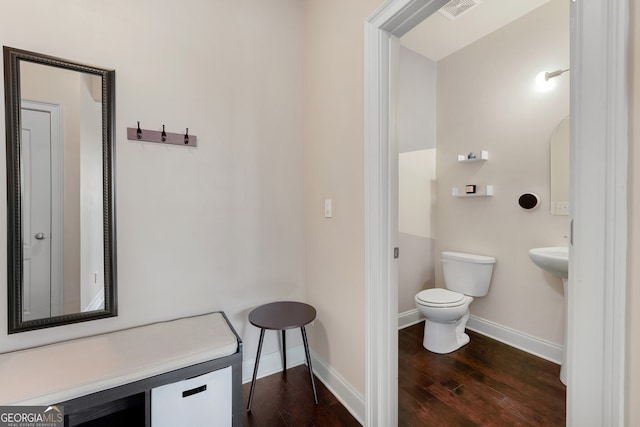 bathroom with hardwood / wood-style flooring and toilet