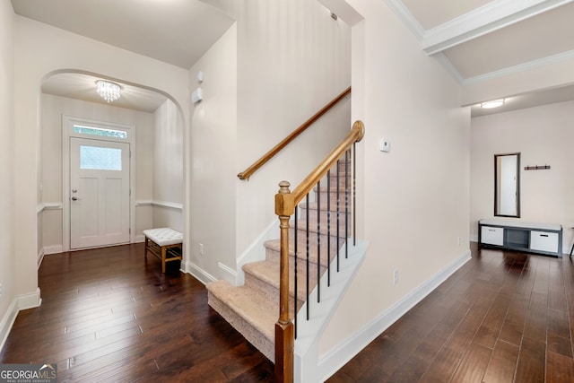 entryway featuring crown molding and dark hardwood / wood-style floors