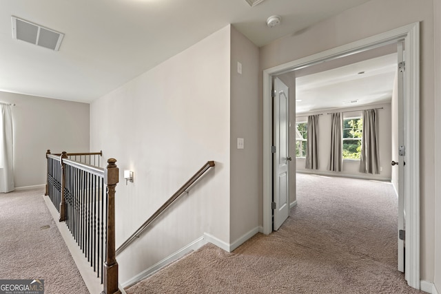 corridor featuring light carpet