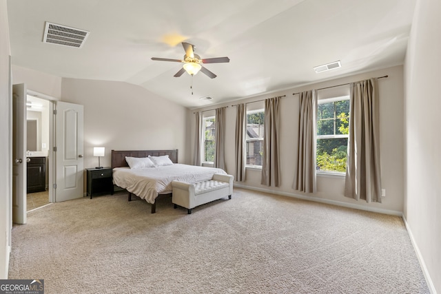 carpeted bedroom with multiple windows, ceiling fan, and lofted ceiling