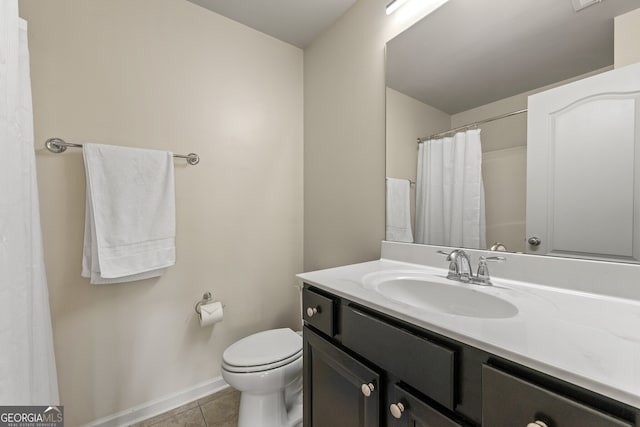 bathroom featuring tile patterned floors, vanity, and toilet